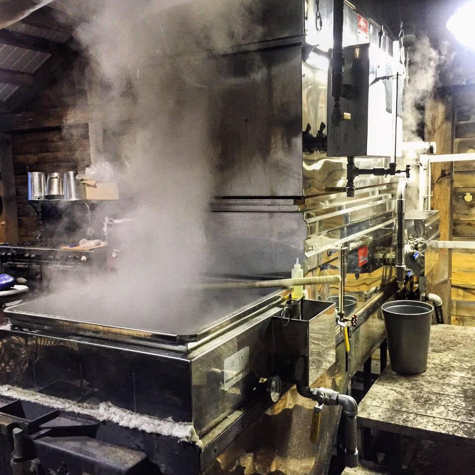 An evaporator inside a sugarhouse during sugaring season in late winter / early spring. This machine allows a wood fire to continually heat pans as the sap flows through from chamber to chamber; the closer the sap runs to the last chamber, the closer it gets to the fire, concentrating the sap down in to maple syrup. 