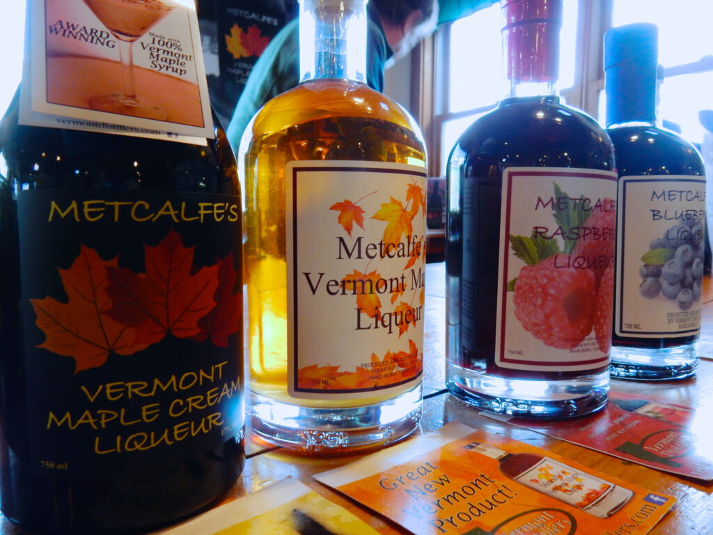 A photo of multiple bottles of Vermont distilled liquors. Metcalfe's Distillery in southern Vermont creates unique and distinctive maple and New England inspired spirits.