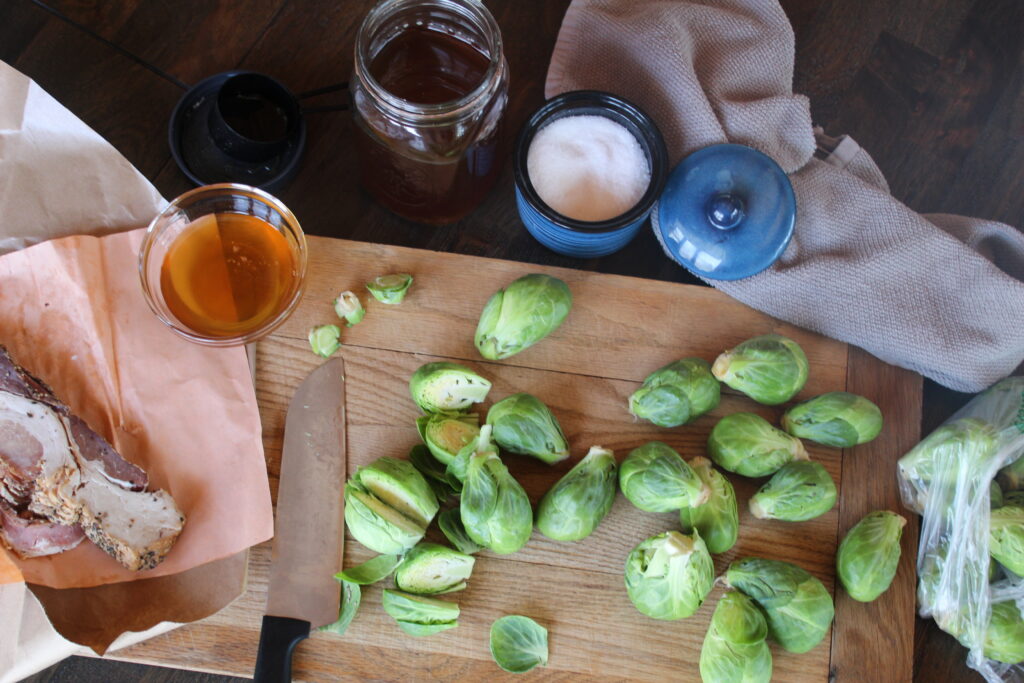 Ingredients for Maple Roasted Brussels Sprouts with Bacon are laid out before roasting 