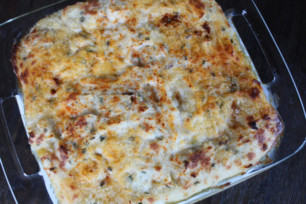 A pan of shepherd's pie hot out of the oven with a beautiful browned top from a few minutes of broiling at the end