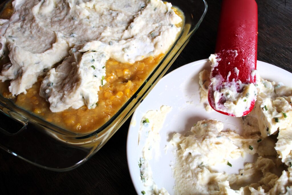 Chive and sour cream mashed potatoes are added as the top layer of a shepherd's pie, over a layer of corn and a layer of ground beef and ground sausage