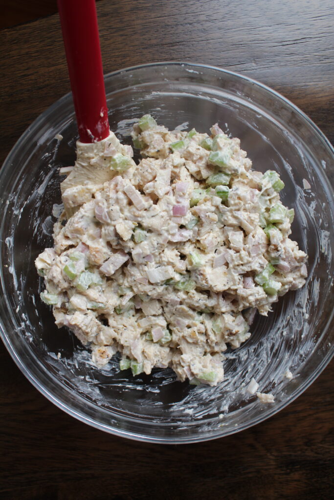 My favorite chicken salad recipe is mixed in a glass bowl, ready for a quick, healthy, wholesome lunch