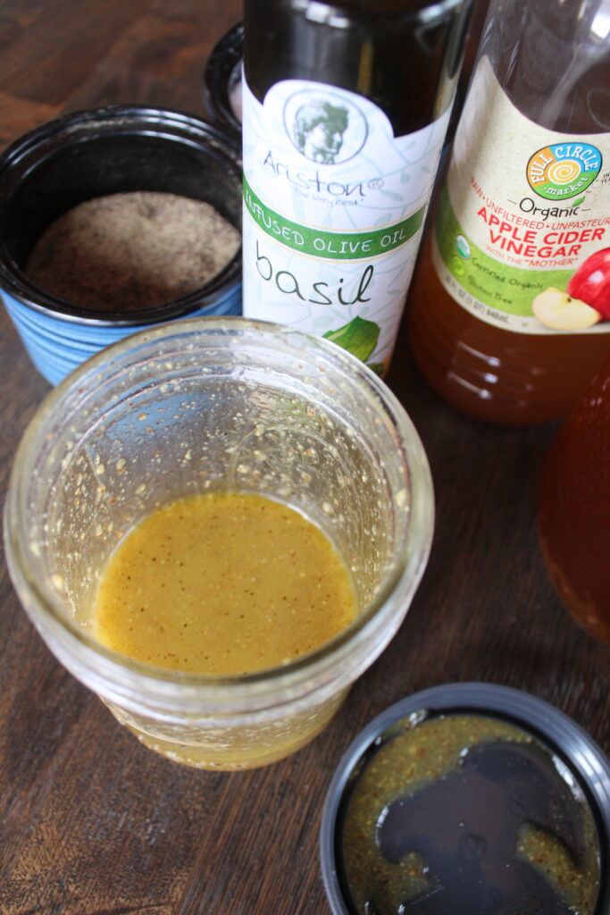 Maple Dijon Basil Vinaigrette mixed up in a ball mason jar