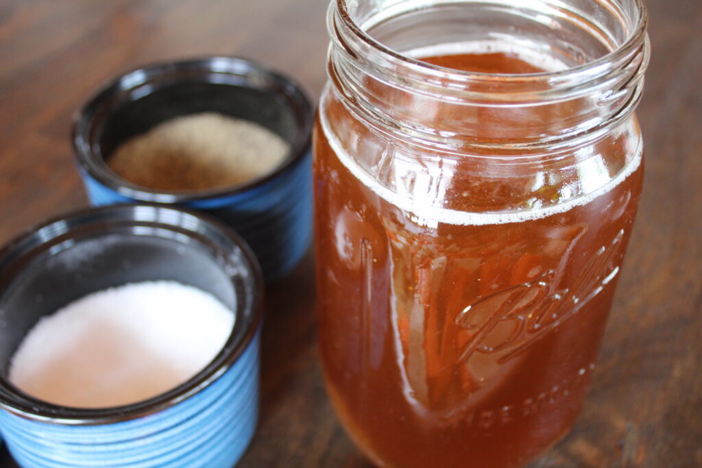 Pure maple syrup in a mason jar. A key ingredient in Maple Dijon Basil Vinaigrette, it adds a sweetness and earthiness that elevates this salad dressing